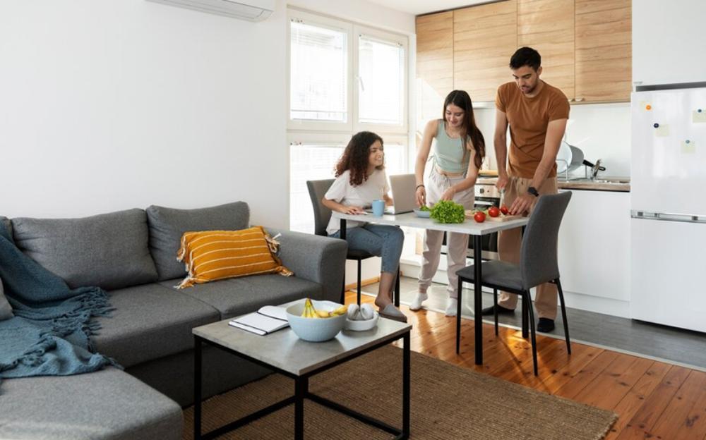 Casual kitchen gathering, friends preparing food together.