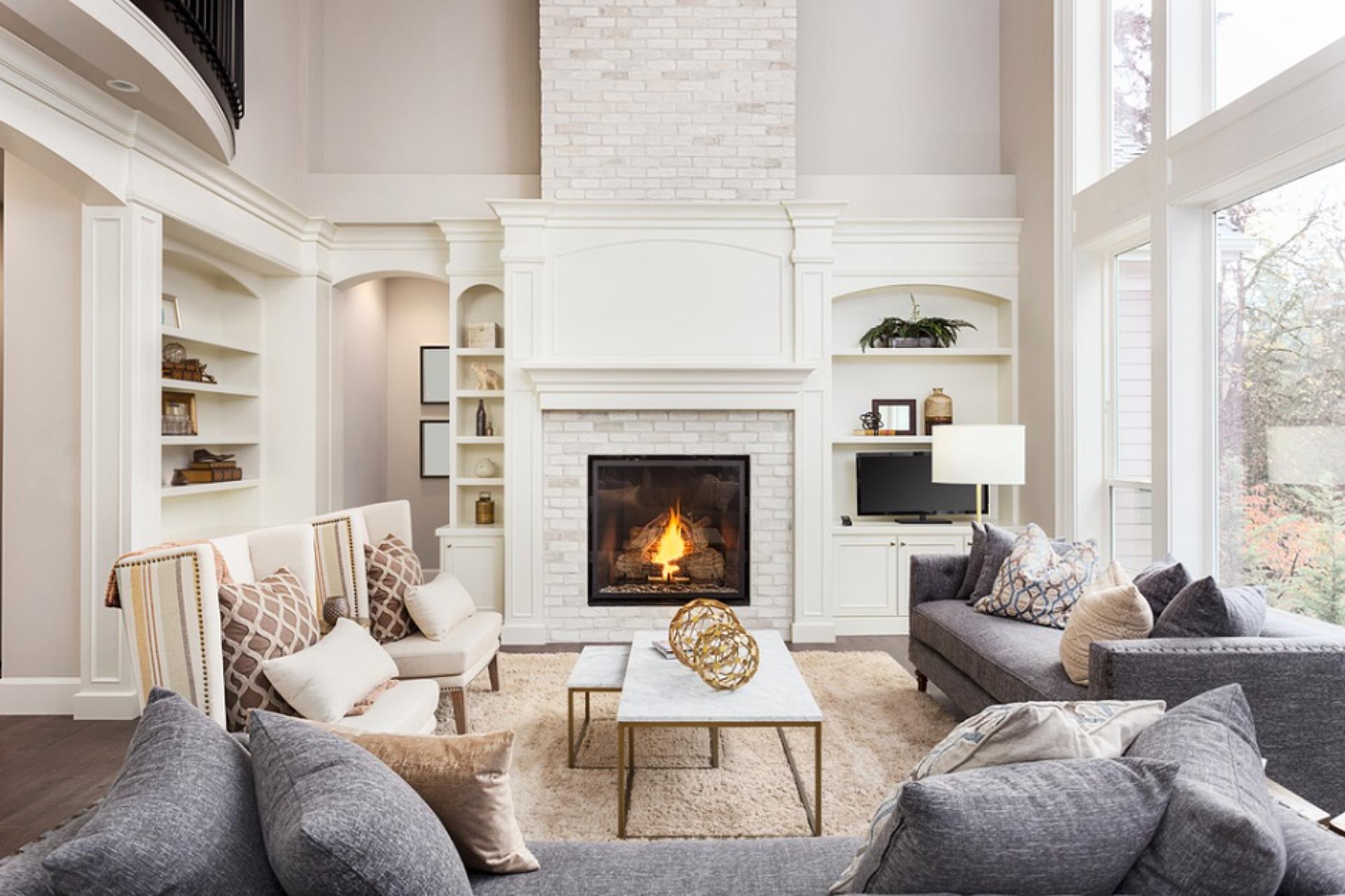 Elegant living room, fireplace, neutral color scheme.