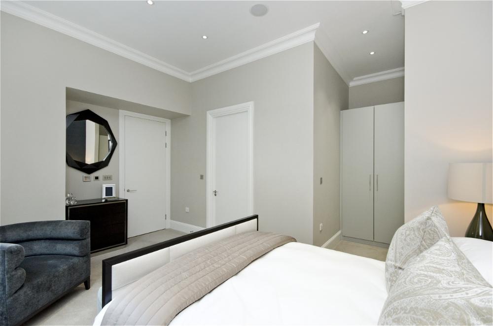 Minimalist bedroom, neutral tones, sleek furniture.