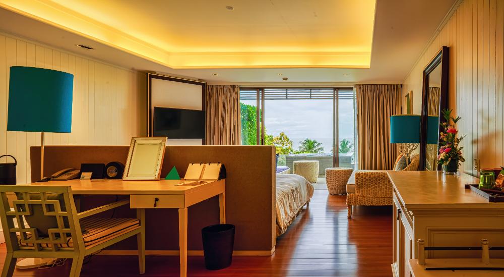 Luxurious suite, ocean view, stylish workspace.